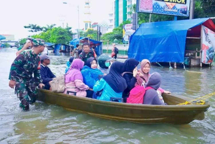 Personil TNI membantu warga korban banjir Genuk dan Kaligawe untuk dievakuasi ke tempat pengungsian. Istimewa